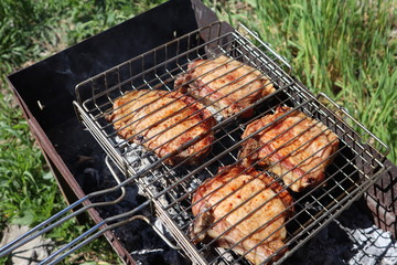 Pork steaks cooked on a charcoal grill outdoors