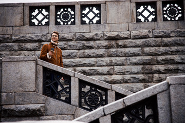Smiling man on gorgeous old stairs in the city stock photo