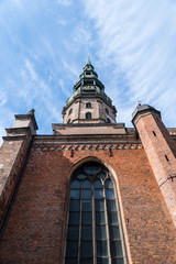 Obraz premium brick tower with a large window against the sky, bottom view