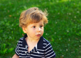 Cute little boy outdoors. A child plays in the yard.