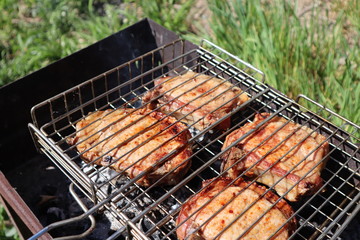 Pork steaks cooked on a charcoal grill outdoors