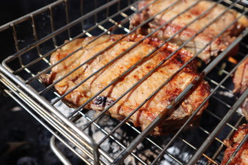 Pork steaks cooked on a charcoal grill outdoors