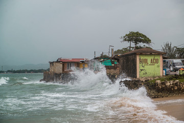 waves crash against coastal village in Jamaica 