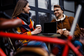 Positive couple with coffee and laptop in the cafe stock photo