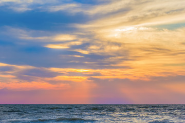 Naklejka na ściany i meble Scenic sunset over the blue evening sea