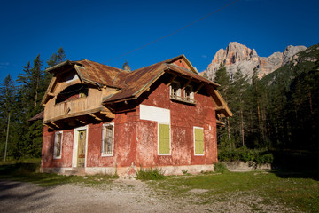 Nice red, abandoned building standing in the Dolomites