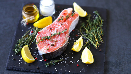 Salted salmon slice with sea salt and spices on a stone board. Keto Paleo. Pegan diet.