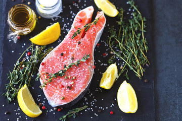 Salted salmon slice with sea salt and spices on a stone board. Keto Paleo. Pegan diet.