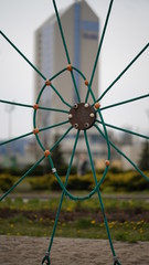 Net of ropes in a city park on the background of a high-rise building