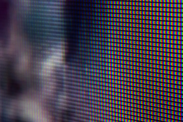 Macro of television pixels with dark blue and red dominants and bokeh