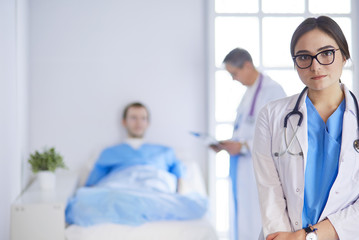 Female doctor using tablet computer in hospital lobby
