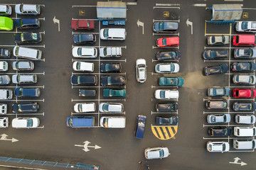 Top view of many cars parked on a parking lot.