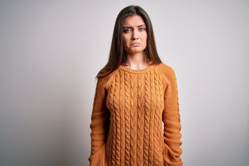 Young beautiful woman with blue eyes wearing casual sweater standing over white background depressed and worry for distress, crying angry and afraid. Sad expression.