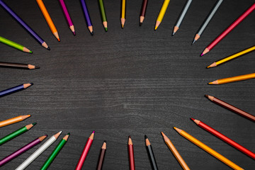 colored pencils on black wooden table