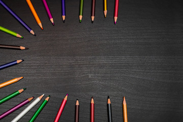 colored pencils on black wooden table