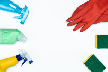flat-lay of Cleaning supplies on white background. Detergents bottles with cleaning liquid with...
