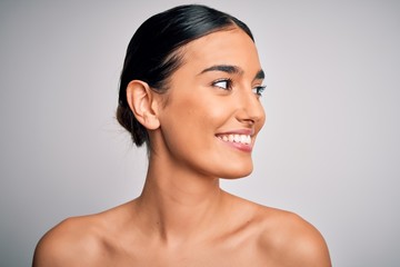 Close up of young beautiful woman with clear and pure skin. Perfect and clean skincare wearing natural makeup. Smiling happy looking fresh and healthy. - obrazy, fototapety, plakaty
