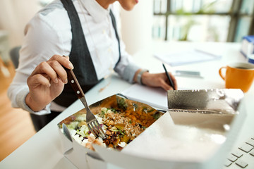 Close-up of businesswoman having lunch break in the office.