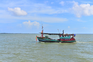 Naklejka na ściany i meble Fishing boat on the sea and blue sky of Thailand