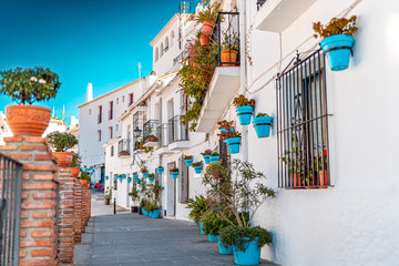 Beautiful view of old Mijas Calle Moro, white houses and aqua blue flower pots. a special and peculiar Spanish mountain town.
