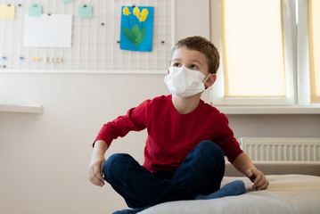 Little boy in sterile mask staying at home