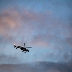 Fototapeta na wymiar helicopter in the sky, aircraft, flying, air, clouds, sunset, chopper, aviation, flight, travel, 