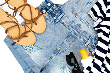 Flat lay summer traveler beach accessories. travel or vacation concept. t-shirt, Jean and beach sandals and sun glasses