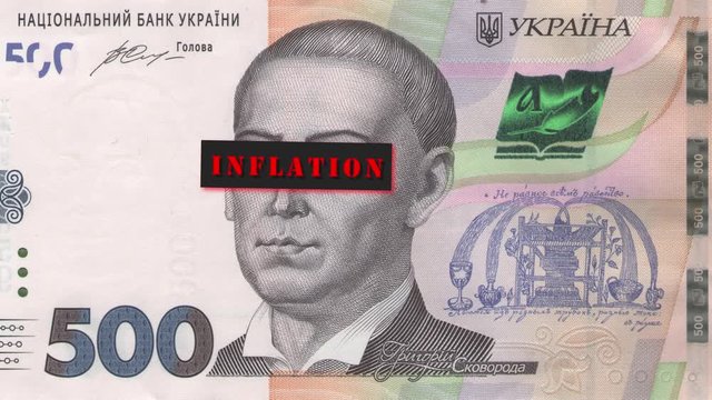 Portrait of Grigoriy Skovoroda from 500 Ukrainian hryvnia bill with a closed eyes and the caption title "inflation". During glitch, the face of the portrait frowns. Economic crisis concept.