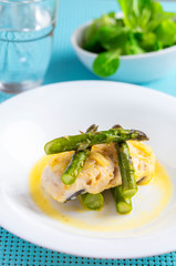 Hake fish cooked with onion, wild asparagus and with meat stock and wild berry juice