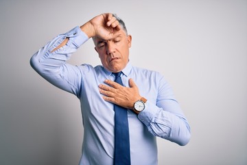 Middle age handsome grey-haired business man wearing elegant shirt and tie Touching forehead for illness and fever, flu and cold, virus sick