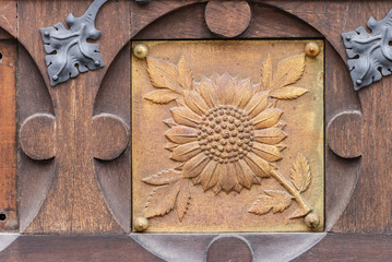 Door with a bas-relief in the Basilica of Brno. Bas-relief with a sunflower on the large door to the Church.