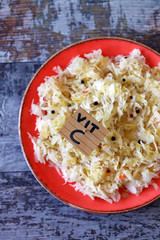 Selective focus. Note with the inscription Vit C in a plate with sauerkraut. Healthy homemade food. Fermented foods. Probiotics