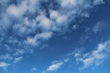White clouds and blue sky as background. Photo of sky in sunny day. Nature background.