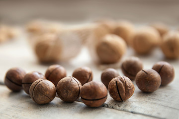 nuts in their shells on a white wooden background