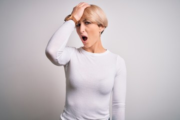 Young beautiful blonde woman with modern short hair hairstyle standing over isolated background...