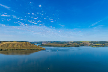 top scenic view Ukraine land summer country side peaceful landscape small hills and river calm waters clear weather day time
