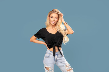 Fashionable blonde woman in jeans.