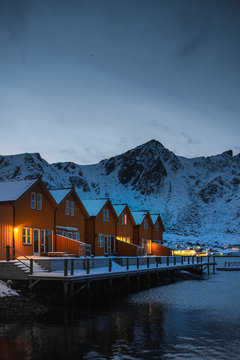 Orange cabins by the lake in Ballstad village, Norway