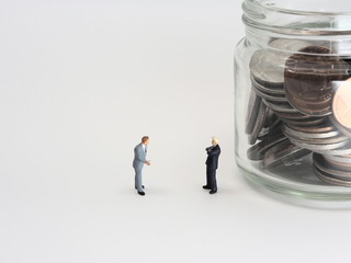 A miniature businessman asking to borrow money from a rich man.Borrowing money concept image.
