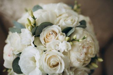 Beautiful wedding bouquet and gold rings