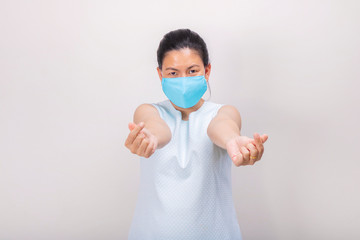 An Asian girl in blue tank top wears blue mask