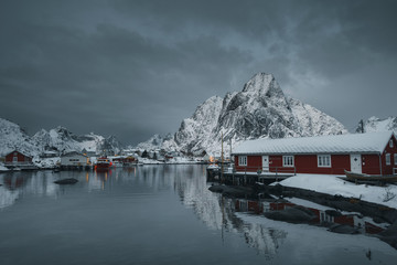 Red cabins on a snowy Reine in Moskenesøya island, Norway