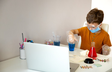 Concentrated little schoolboy playing alone at home