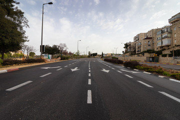 Fototapeta na wymiar Jerusalem, Israel - Ha-Rav Herzog Street - 27 03 2020: empty streets during Corona Virus quarantine A view of the main road