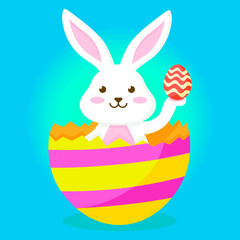 Cute rabbit joyfully climbs out of an Easter egg with a smaller Easter egg in his hand