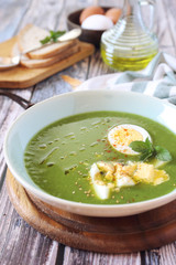 Green pea soup with spinach, olive oil, sesame and boiled egg