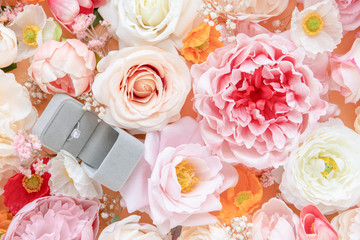 A wedding ring box on roses