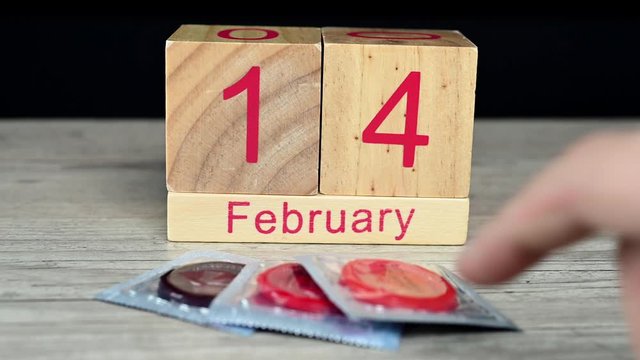 Hand grabbing a condom - Valentines day concept 