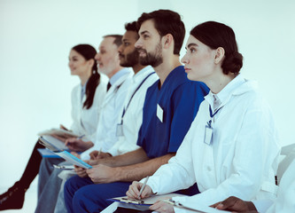 Medical workers taking notes during conference in clinic