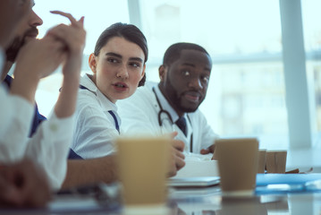 Medical workers sitting at the table in conference room